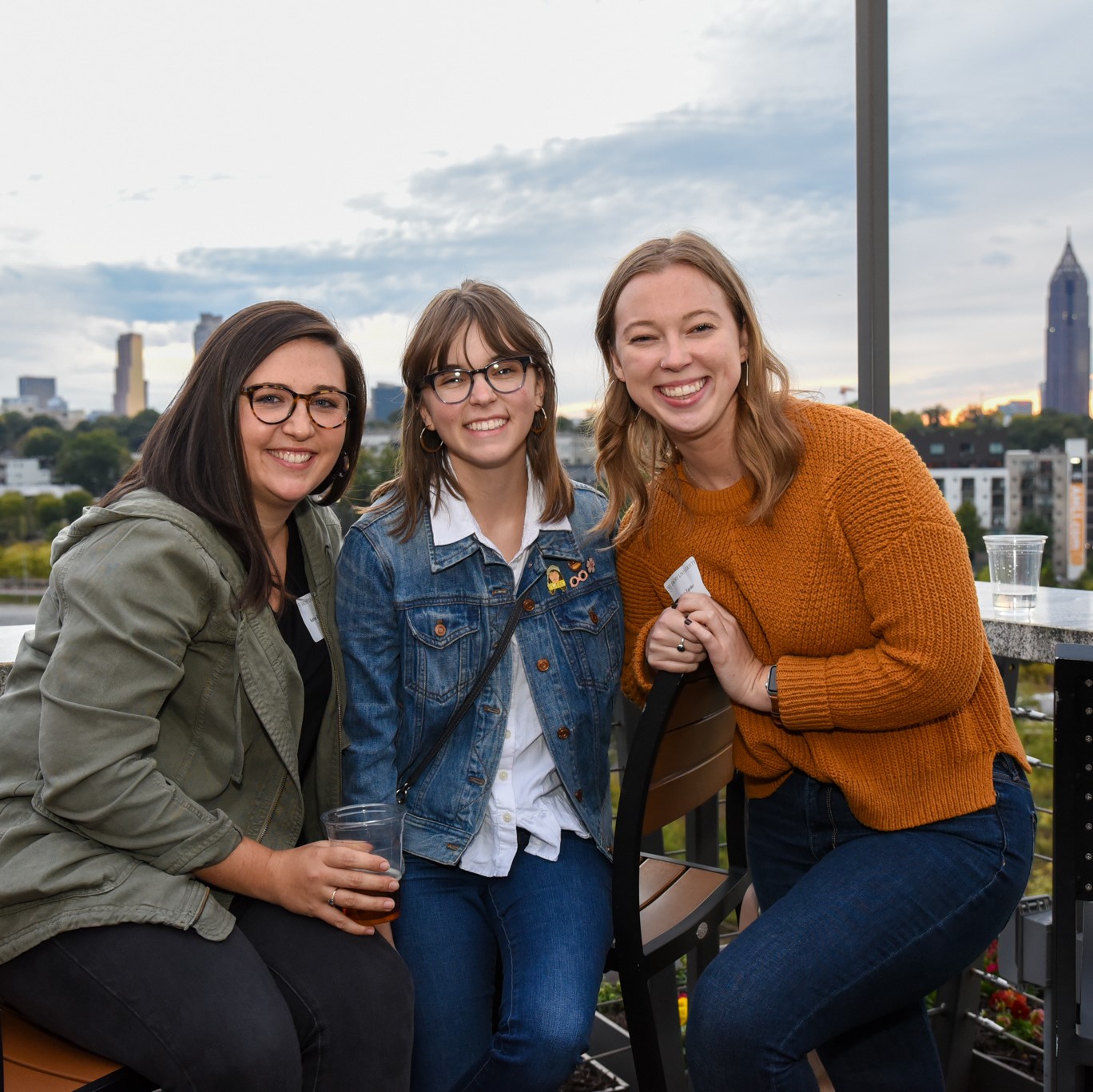 Three female alumni at a networking event.