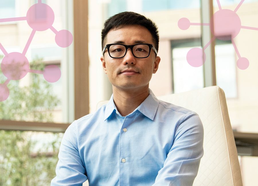 an asian man wearing glasses and a light blue shirt looking concerned at the camera.