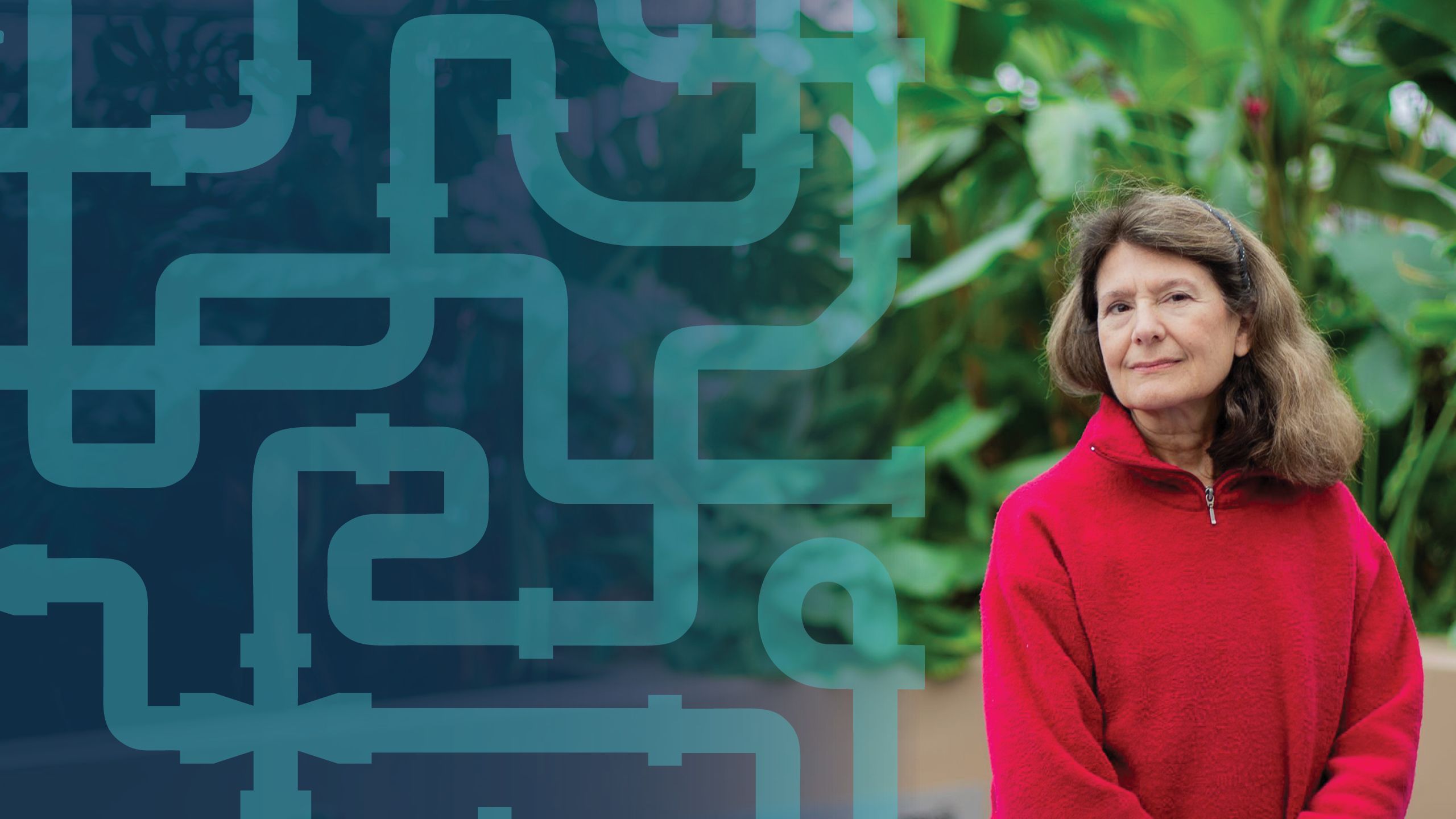 a portrait of christine moe standing in front of large tropical plants.