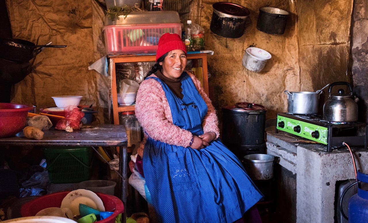Woman in Peru using indoor cookstove