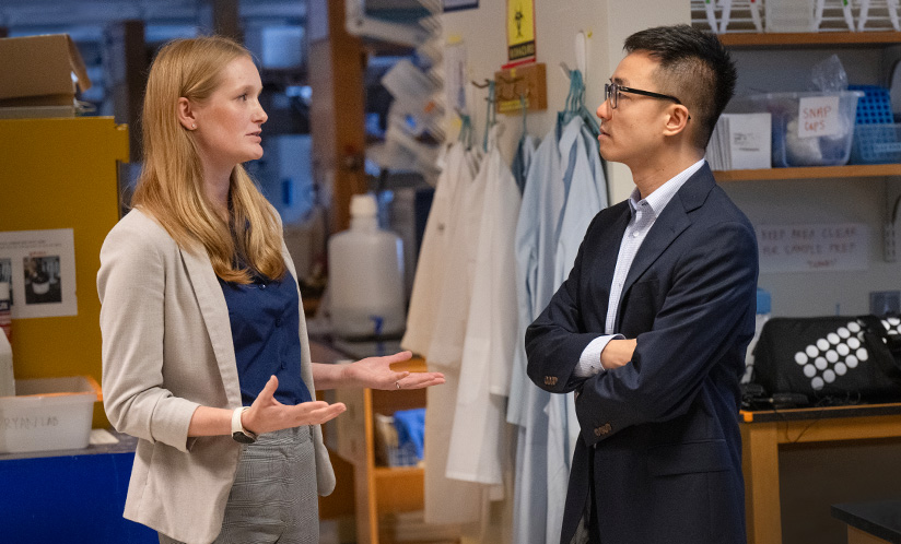 Female and male researcher speaking in lab