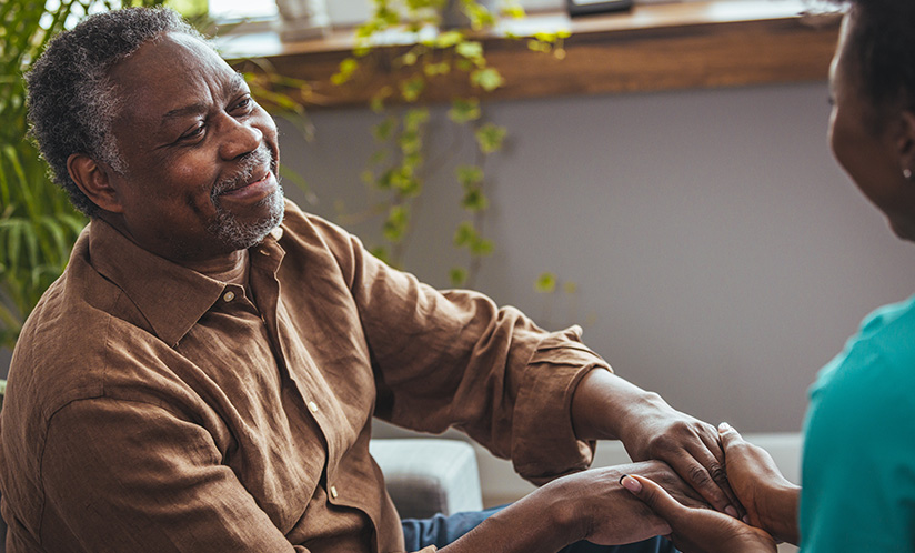 Elderly Black man holding hands with a Black woman