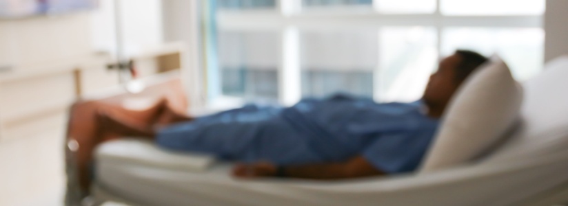 Blurred image of a patient in a hospital bed