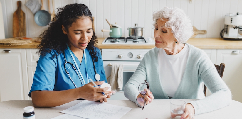 Younger woman working with older woman