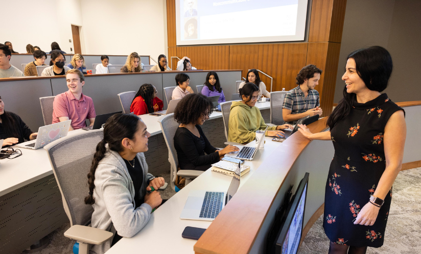 Students sitting in a lecture hall taking notes