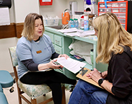 Researcher surveying study participant