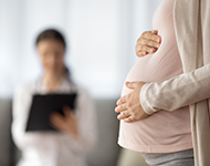 Pregnant woman and doctor