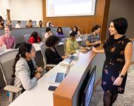 Students sitting in a lecture hall taking notes