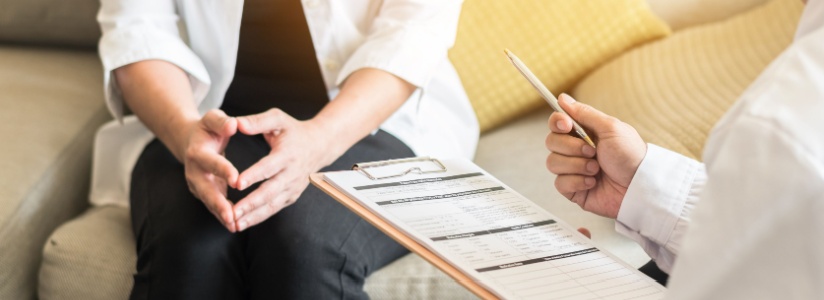 Woman sitting with doctor