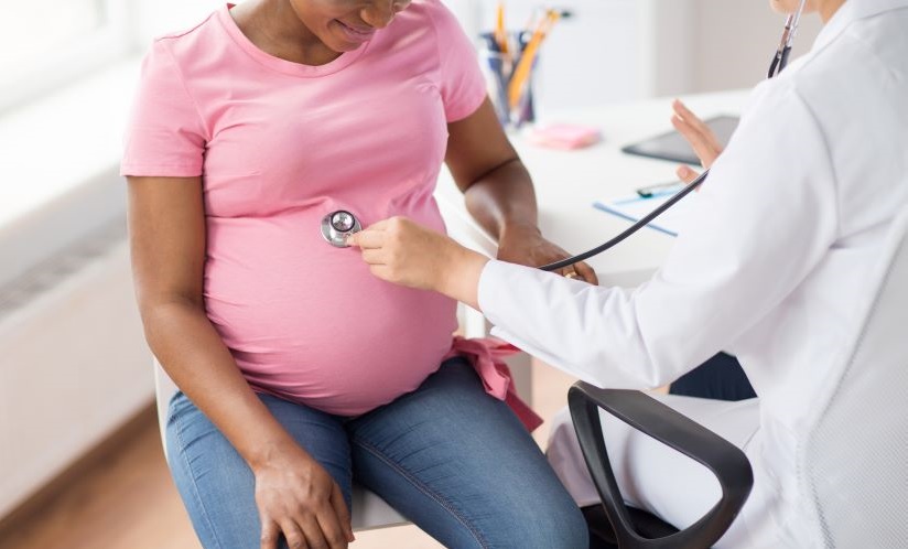 Pregnant woman with doctor