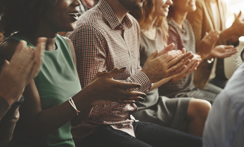 people clapping in an audience