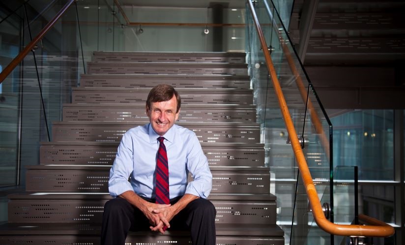 James W. Curran sitting on a staircase