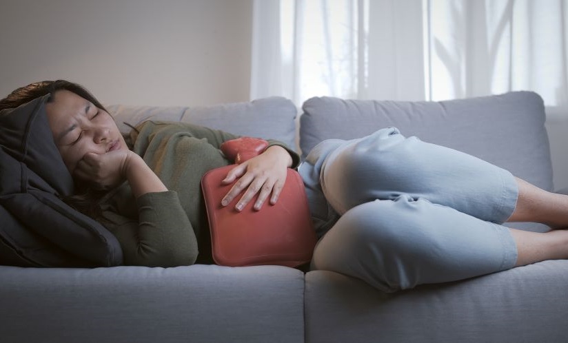 A woman experiencing heavy menstrual bleeding