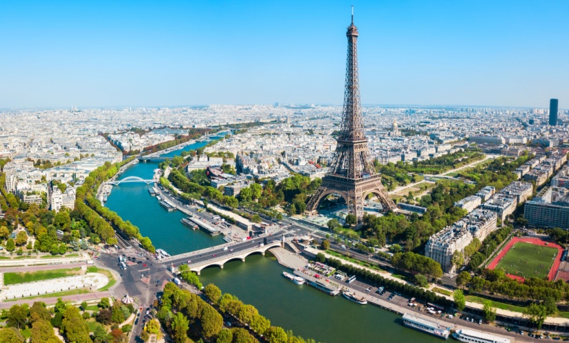 The Seine River in Paris flowing next to the Eiffel Tower.