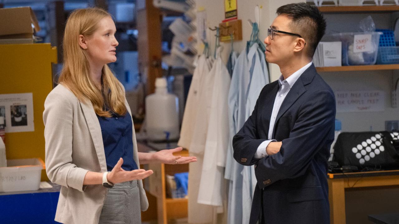 Female and male researcher speaking in lab