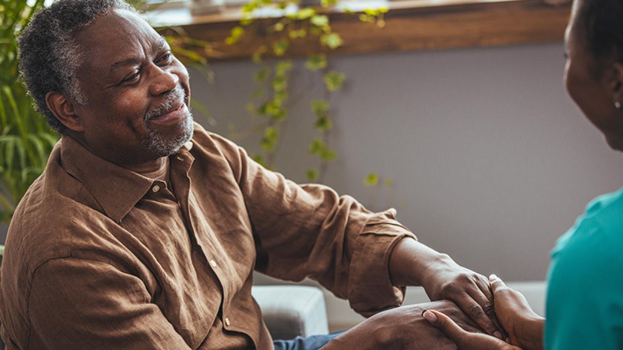 Elderly Black man holding hands with a Black woman