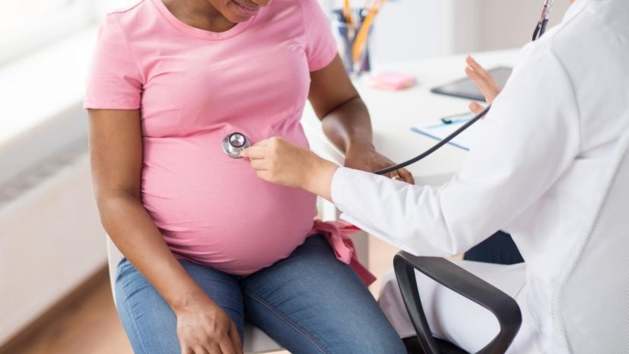 Pregnant woman with doctor