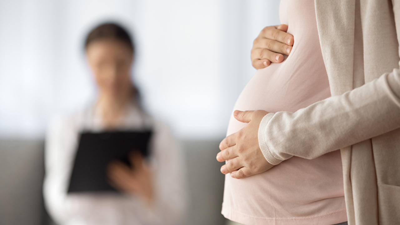 Pregnant woman with doctor