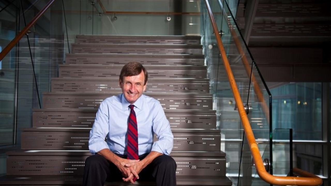 James W. Curran sitting on a staircase