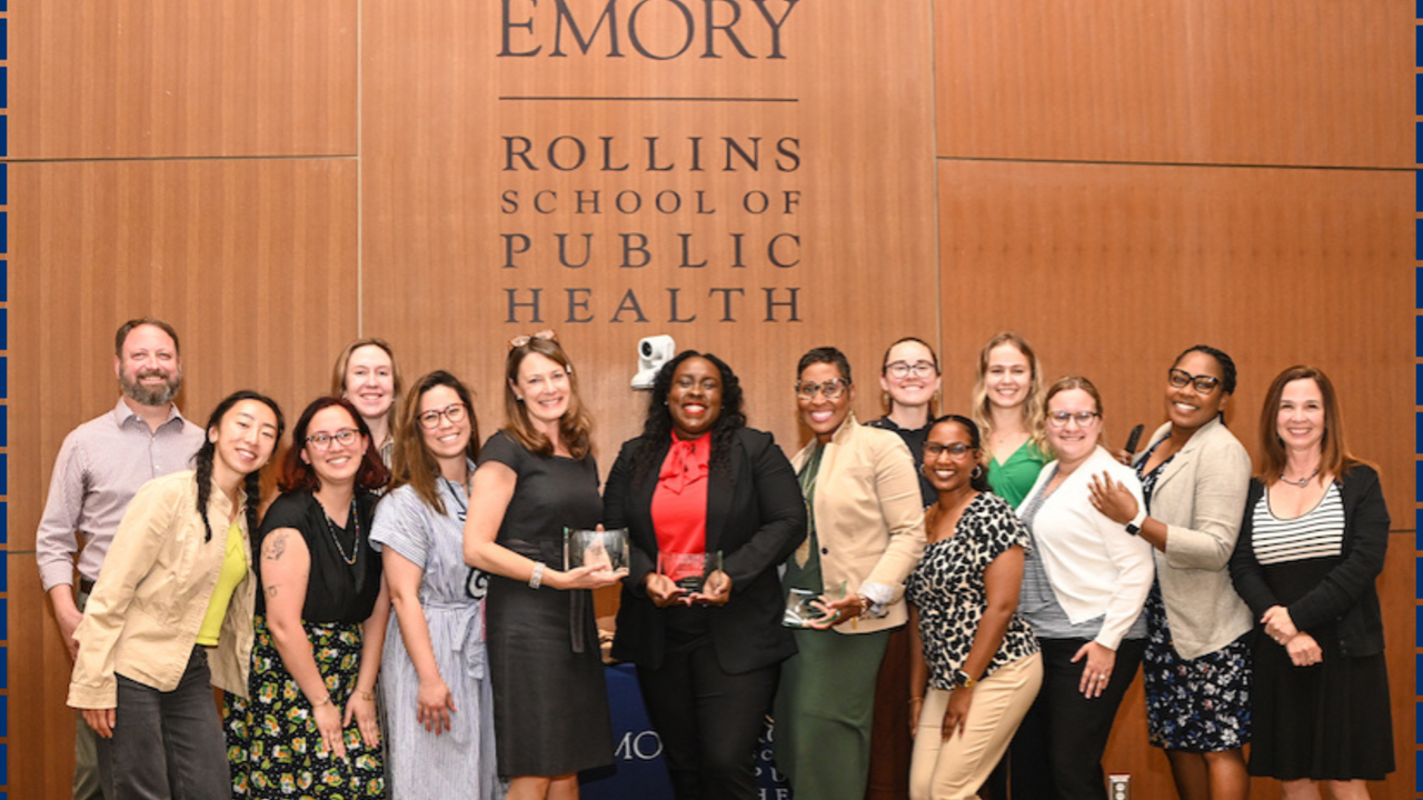 Group of people on a stage holding awards