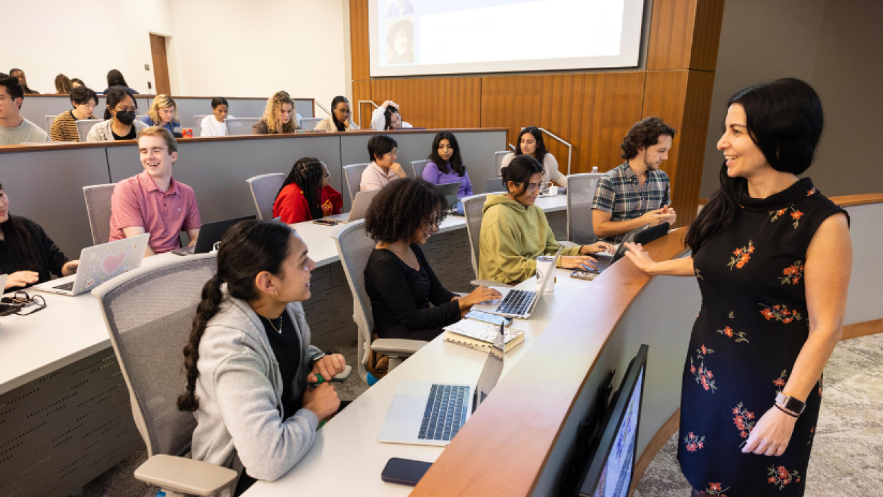 Students sitting in a lecture hall taking notes