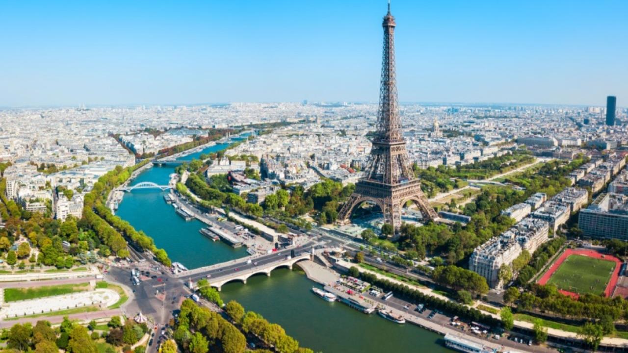 The Seine River in Paris flowing next to the Eiffel Tower.
